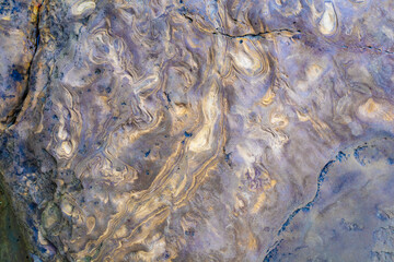 The texture of black sand washed by water
