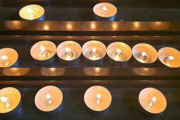 Candles up close inside a church