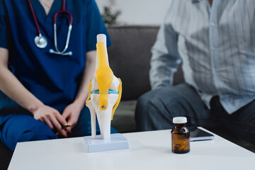 A young Caucasian female nurse provides medical consultation to an elderly Caucasian male patient...