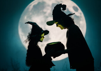 Woman and her daughter dressed in witch costumes