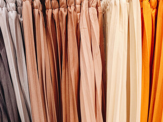 Colorful women's clothing on hangers in a retail store. Fashion and shopping concept