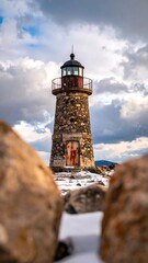 Lighthouse amidst winter rocks