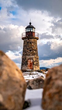 Lighthouse amidst winter rocks