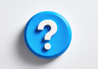 A bright, vibrant, round, blue button featuring a prominent white question mark