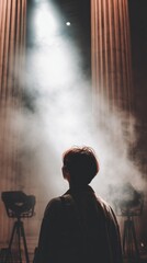 Obraz premium Silhouette of a person standing in fog with dramatic lights illuminating the background