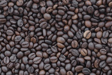 Coffee texture roasted beans from above soft light. Big amount of coffee