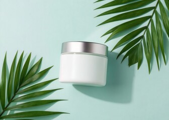 White cosmetic jar with silver lid surrounded by green palm leaves on a light blue background white jar
