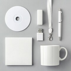White promotional merchandise flat lay with C D U S B stick pen lanyard notebook and mug branding