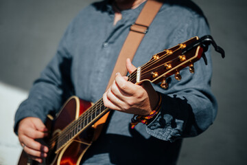 Musician Playing Acoustic Guitar in Warm Sunlight
