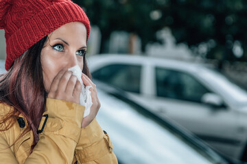 Young Woman Fighting a Cold While Walking Outside