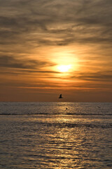 Sunset over the sea, golden light reflections and silent expanse