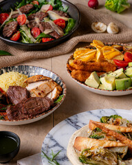 Featuring grilled steak and chicken, fresh salad, avocado, and crispy potatoes, this shot appeals to those looking for a healthy yet satisfying meal. It's ideal for fitness and healthy lifestyle conte