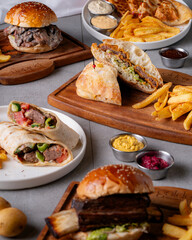 With a variety of sandwiches, burgers, and wraps, this photo represents a rich and diverse menu. It's an ideal choice for restaurant advertisements, social media campaigns, and content related to food