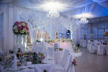 Elegant wedding reception with floral decorations and ambient lighting in a grand venue