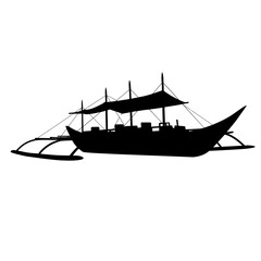 Silhouette of a traditional filipino outrigger boat sailing on the sea with sails up