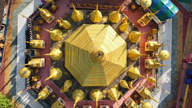 A large chedi temple surrounded by smaller golden chedis