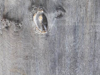Close up of weathered gray wood with knot and natural texture