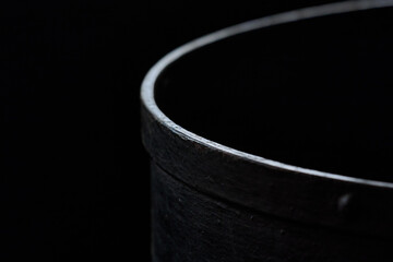 A close-up view of a dark industrial coil inside the gas museum in Warsaw, revealing its circular form and subtle lighting