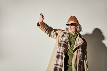 Stylish senior man showcasing trendsetting fashion in a modern urban setting