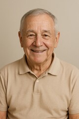 Joyful Senior Portrait: A heartwarming close-up captures a smiling older gentleman against a neutral backdrop, radiating positivity and embodying wisdom and experience. 