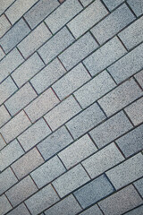 A brick wall with a gray and white color