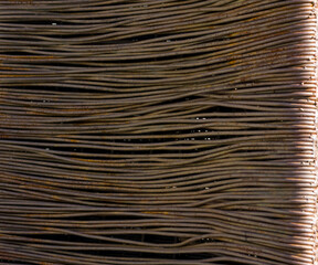 Close up of stacked rusted metal rods with linear pattern