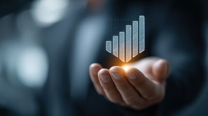 A hand holds a glowing, holographic bar chart symbolizing growth, finance, and business success in a futuristic, digital setting.