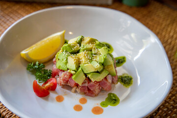 Culinary Composition: A culinary masterpiece featuring avocado, meticulously arranged on a pristine white plate. The composition captures the freshness and artistry of a gourmet dish.