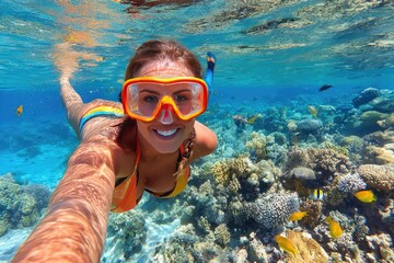 Woman snorkeling, underwater selfie, vibrant coral reef