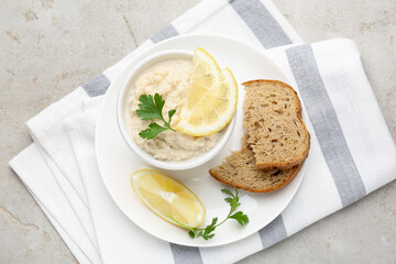 Tasty horseradish sauce with parsley and lemon slices served on light table, top view