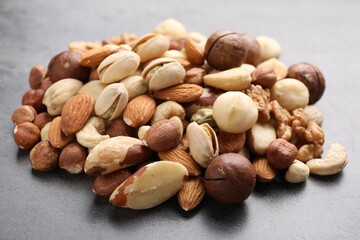 Mix of different nuts on grey table, closeup