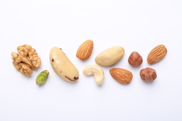 Mix of different nuts on white background, flat lay