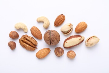 Mix of different nuts on white background, flat lay
