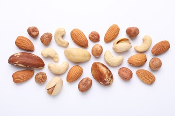 Mix of different nuts on white background, flat lay