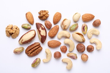 Mix of different nuts on white background, flat lay