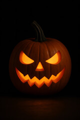 Scary carved Halloween pumpkin jack o lantern glowing in dark