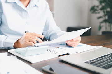 Businesswoman manages finances by using banking and accounting system to calculate costs, taxes, investments, illustrating a business, finance, and real estate concept focused on financial strategy.