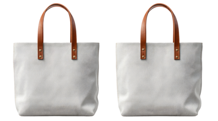 Two light gray canvas tote bags with tan leather handles