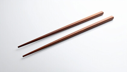 Elegant dark-red wooden chopsticks on a white background.