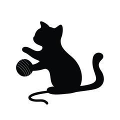 Silhouette of a playful cat batting at a ball of yarn