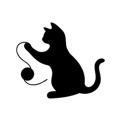 Silhouette of a black cat playing with a ball of yarn playfully