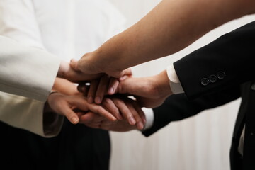Obraz premium The group of employees hand in hand to show the best teamwork collaboration .Membership togetherness partnership and success Concept