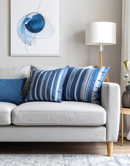 Light gray couch with blue striped pillows and artwork