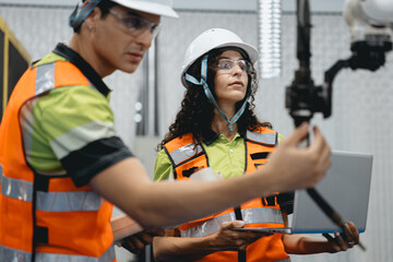 Smart Latino woman and male colleague working on AI technology in robotic electronic engineering...