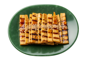 Grilled bamboo shoots, glazed with a savory sauce and topped with sesame seeds, arranged attractively on a jade-green plate.