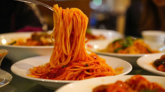 Enjoying a delicious plate of spaghetti at a cozy restaurant during dinner time with friends and family