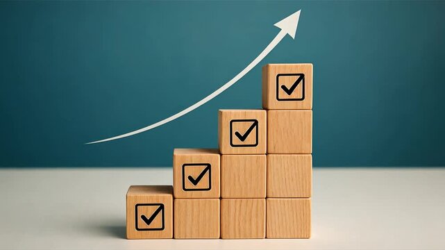 Wooden blocks arranged in spiral stack with checkmark icons rising higher arrow line moving upward on teal background symbolizing growth and progress