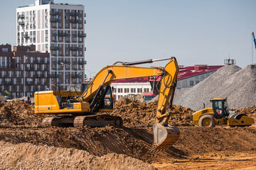 An excavator is digging the ground with a bucket for construction. Close-up of an excavator on a...
