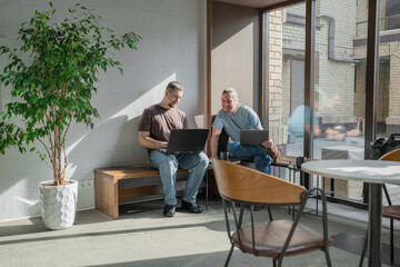 Two knowledgeable professionals collaborating effectively together in a modern workspace setting