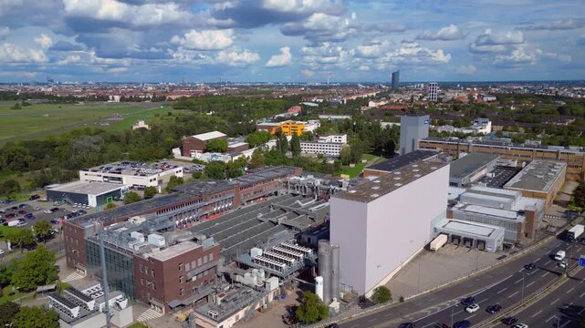 Berlin's industrial area with Bahlsen, Procter Gamble Gillette, Ufa Film factories and highways under a sunny sky. Nice aerial view flight panorama overview drone